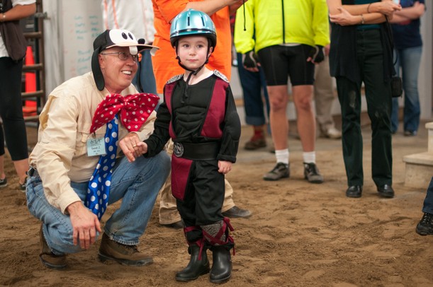 David Jessen, Ann Arbor, holds the hand of Jansen Sweeny, 6 of Belleville, at the Harold and Kay Peplau Therapeutic Riding Center's Halloween Trick-or-Treat horse ride. (Tanya Moutzalias for AnnArbor.com)
